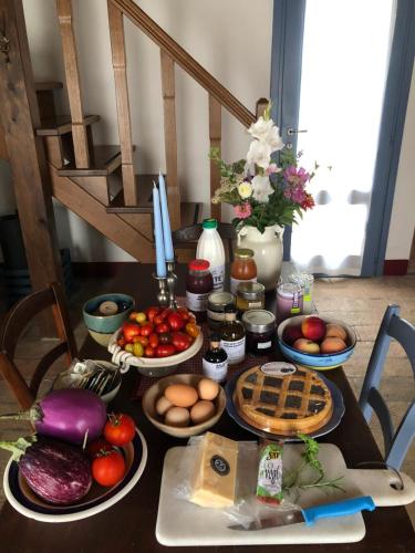 a table with many plates of food on it at Agriturismo Podere Prasiano in Marano sul Panaro