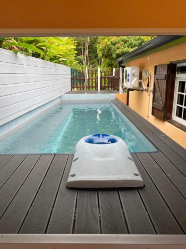 a swimming pool with avertisementatronatronstrationstrationstrationstrationstrationstration at villa sofaia Guadeloupe in Sainte-Rose