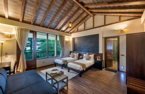 a living room with a couch and a table at Hotel Eagles Nest in Dharamshala