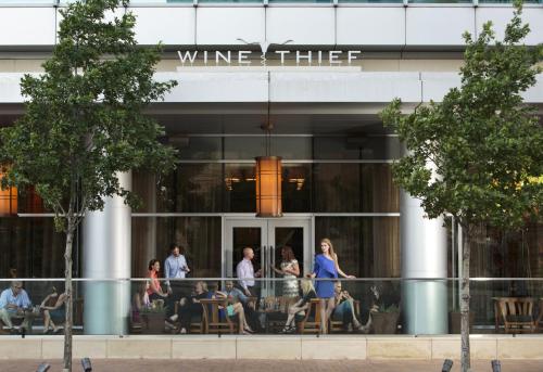 a group of people walking in front of a building at Omni Fort Worth Hotel in Fort Worth