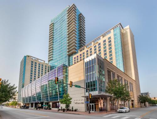two tall buildings on a city street with a traffic light at Omni Fort Worth Hotel in Fort Worth