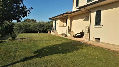 a backyard of a house with a grass yard at Elisa House in Foligno