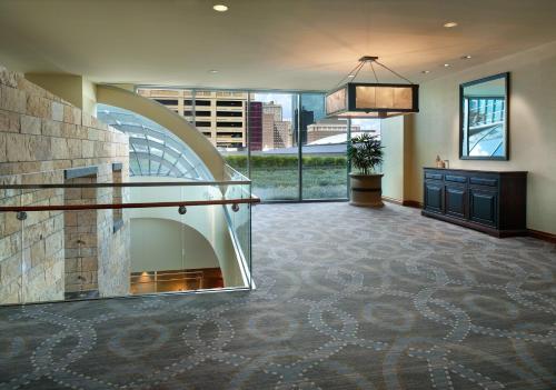 a lobby with a fireplace in the middle of a building at Omni Fort Worth Hotel in Fort Worth