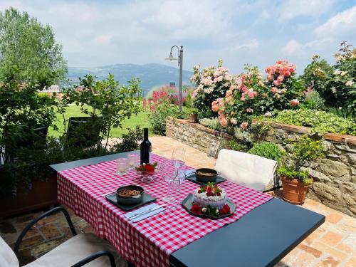 a table with a red and white checkered table cloth at Agriturismo Podere Prasiano in Marano sul Panaro
