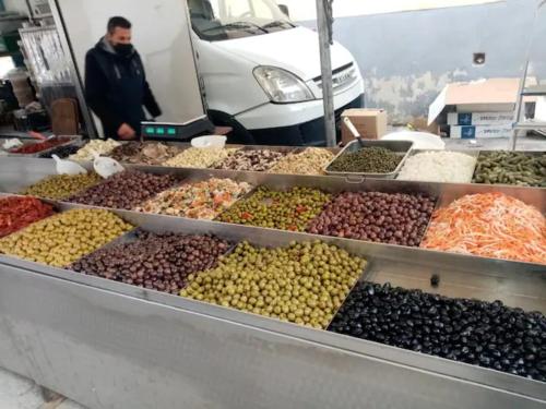 a display of olives and other fruits and vegetables at SoleLuna Apartment 2 in Santa Elisabetta