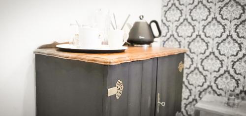a black cabinet with a wooden top in a room at The Lux Guesthouse in Kroonstad