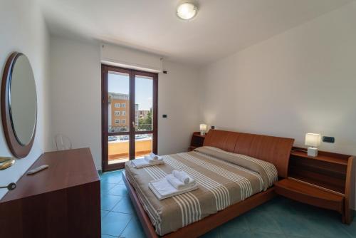 a bedroom with a bed and a sink and a mirror at Pepigall vista mare in Alghero