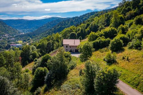an aerial view of a house on a hill with trees at Le 11 des Bouchaux, Gîte d'exception in La Bresse