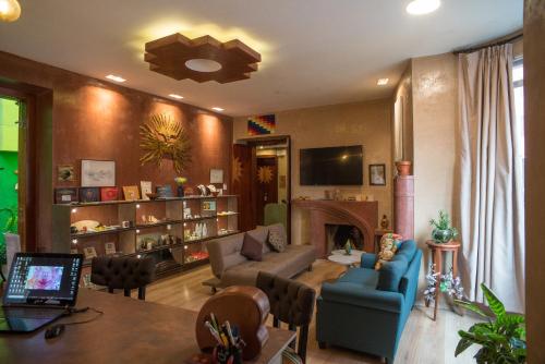 Chakana Hotel Boutique Centro في كيتو: غرفة معيشة مع أريكة ومدفأة