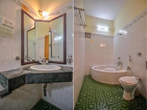 a bathroom with a sink and a tub and a toilet at Goa Garden Resort - Sandray Apartments & Villa at Benaulim - Colva beach in Colva