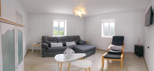 a living room with a couch and a table at Villa Flor Armenteira in Armentera