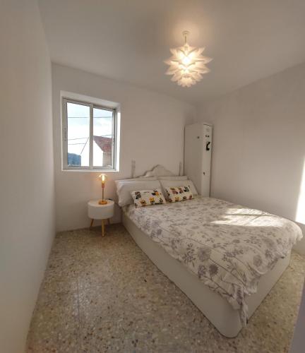 a bedroom with a large bed and a window at Villa Flor Armenteira in Armentera