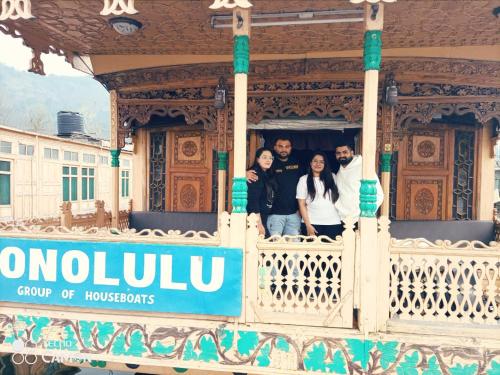a group of people standing on the balcony of a house at Honolulu Group Of Houseboats in Srinagar