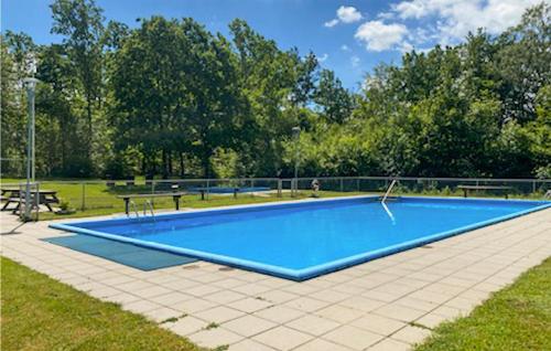 a large blue swimming pool in a park at 3 Bedroom Pet Friendly Home In Hörby in Hörby