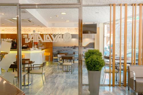 a dining room with tables and chairs in a restaurant at Hotel Atalaya I in Portonovo