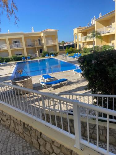 a swimming pool in front of some apartment buildings at Parra Home Holidays - Close to Galé Beach in Guia