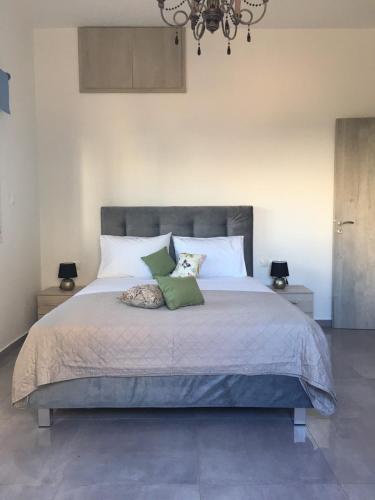 a bedroom with a large bed with two pillows at Paradise House in Ierapetra