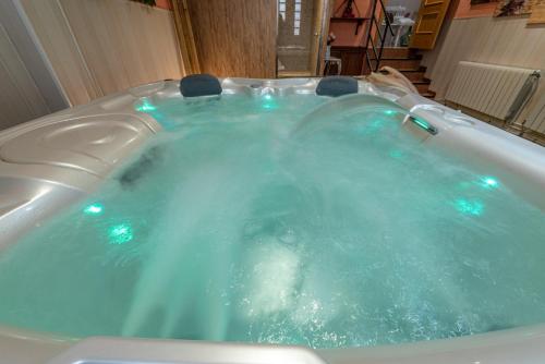 a jacuzzi tub with blue water in it at Los Valles & Spa in Pepino