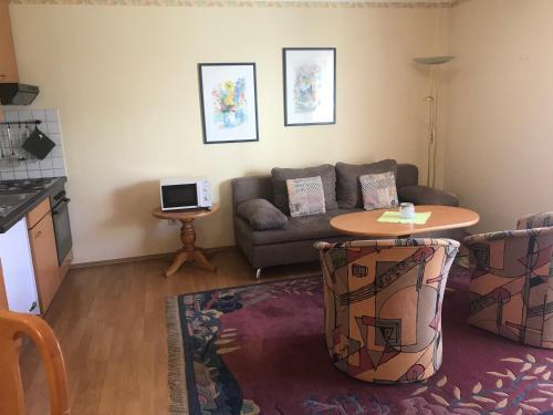 a living room with a couch and a table at Ferienresidenz Am weißen Regen in Bad Koetzting