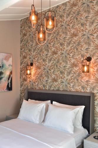 a bedroom with a large bed with lights above it at Noya Köşk Otel in Adalar