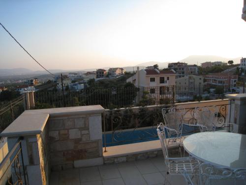 a balcony with a table and chairs on a balcony at Apartment with a garden, BBQ, swimming pool and jacuzzi in Drafí