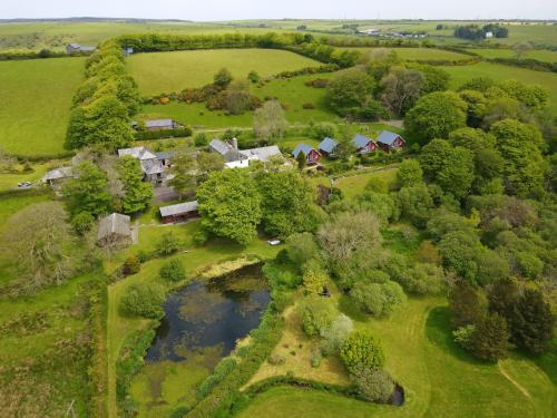 an aerial view of a farm with a pond at Ta Mill Cottages & Lodges - Hayloft Cottage in Launceston