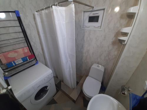a small bathroom with a toilet and a shower at Mountaintop hostel apartments - Hostel Kvish^Khedi in K'vishkhet'i