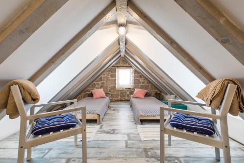 a room in the attic with two beds at Holiday Home Vintage in Split