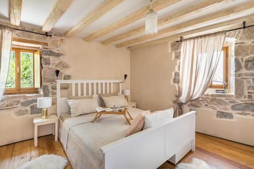 a bedroom with a bed and a stone wall at Holiday Home Vintage in Split