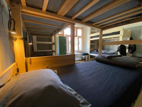 a bedroom with two bunk beds and a mirror at Boutique Hostel Cesis-X in Cēsis