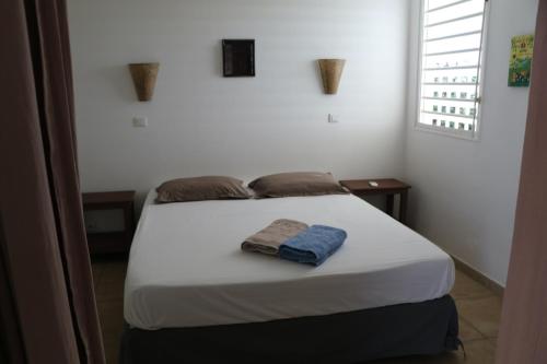 Tempat tidur dalam kamar di BUNGALOW COLOMBO TI-FIGUES