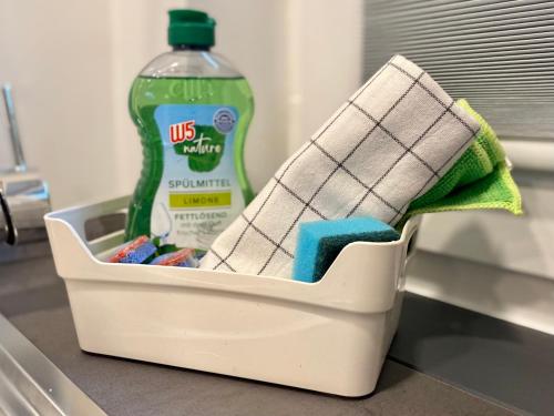 a container with a bottle of cleaner and a sponge at Haus am Iberg 4 in Willingen