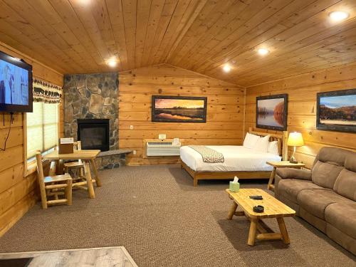 a bedroom with a bed and a tv in a room at The Lodges at Sunset Village in McHenry
