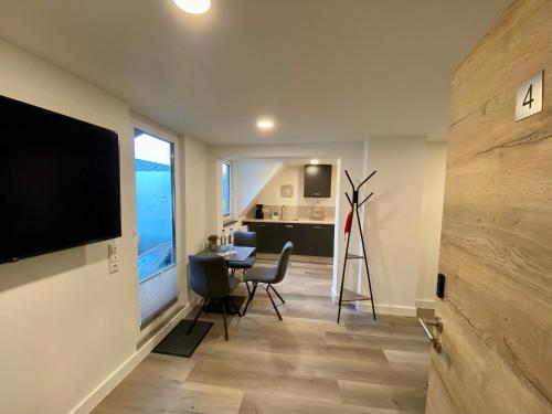 a living room with a flat screen tv on a wall at Haus am Iberg 4 in Willingen