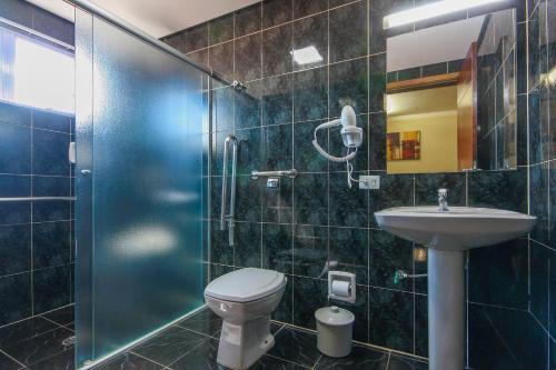a bathroom with a shower and a toilet and a sink at For Lovers Jabaquara in Sao Paulo