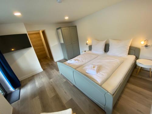 a bedroom with a bed with two stuffed animals on it at Haus am Iberg 4 in Willingen
