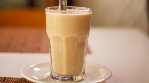 a glass of coffee on a plate on a table at Holiday Inn Tuxpan - Convention Center by IHG in Tuxpan de Rodríguez Cano