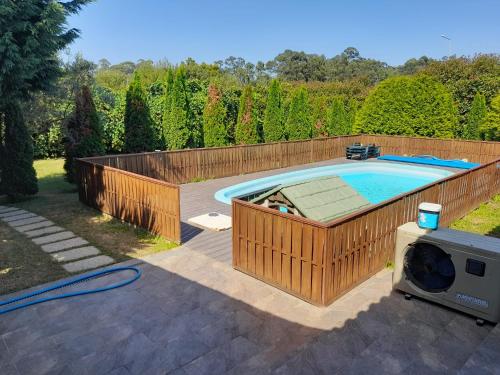 a swimming pool with a wooden fence around it at Refúgio Singelo in Espinho