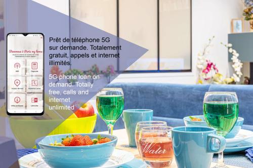 una mesa con un tazón de comida y copas de vino en ParisMyHome - Air-conditioned, 2 shower rooms, 2 toilets, en París