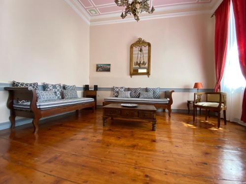 a living room with a couch and two chairs at Eleana Residence in Mithymna