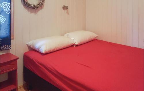 a bed with two pillows on it in a room at Amazing Home In Kvam With Kitchen in Mysusæter