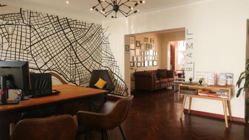 a living room with a wall with a black and white pattern at Lima 18 Boutique in Lima