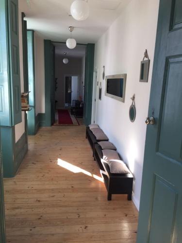 a hallway with a line of benches in a room at Ilha 12 Suites in Coimbra