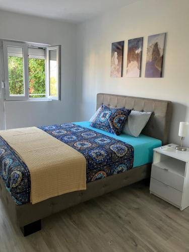 a bedroom with a bed and two windows at Mia Casa in Tivat