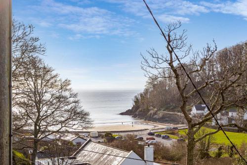 a view of a beach and the ocean at Elmo Lodge in Salcombe