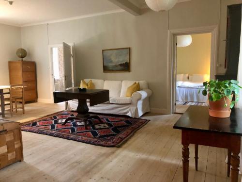 sala de estar con sofá blanco y mesa en Borgviks herrgårdsflygel, en Borgvik