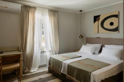 a bedroom with a large bed with a window at Casa Cavi Istria in Oprtalj