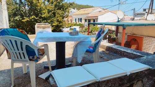 a table and two chairs and a table and chairs at Retro Wooden House Gaios in Gaios