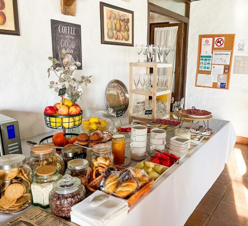 a buffet with many different types of food on it at Hotel Almejí in Benadalid