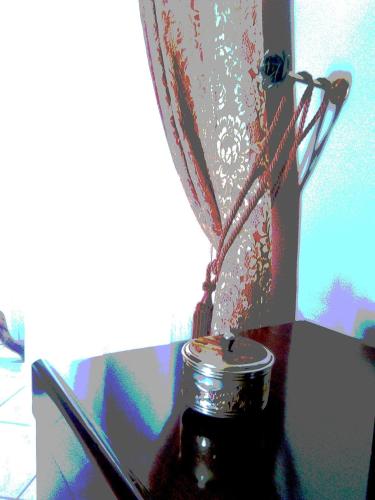 a glass jar sitting on a table next to a window at Casa Vacanze Le Giuseppine in Modica